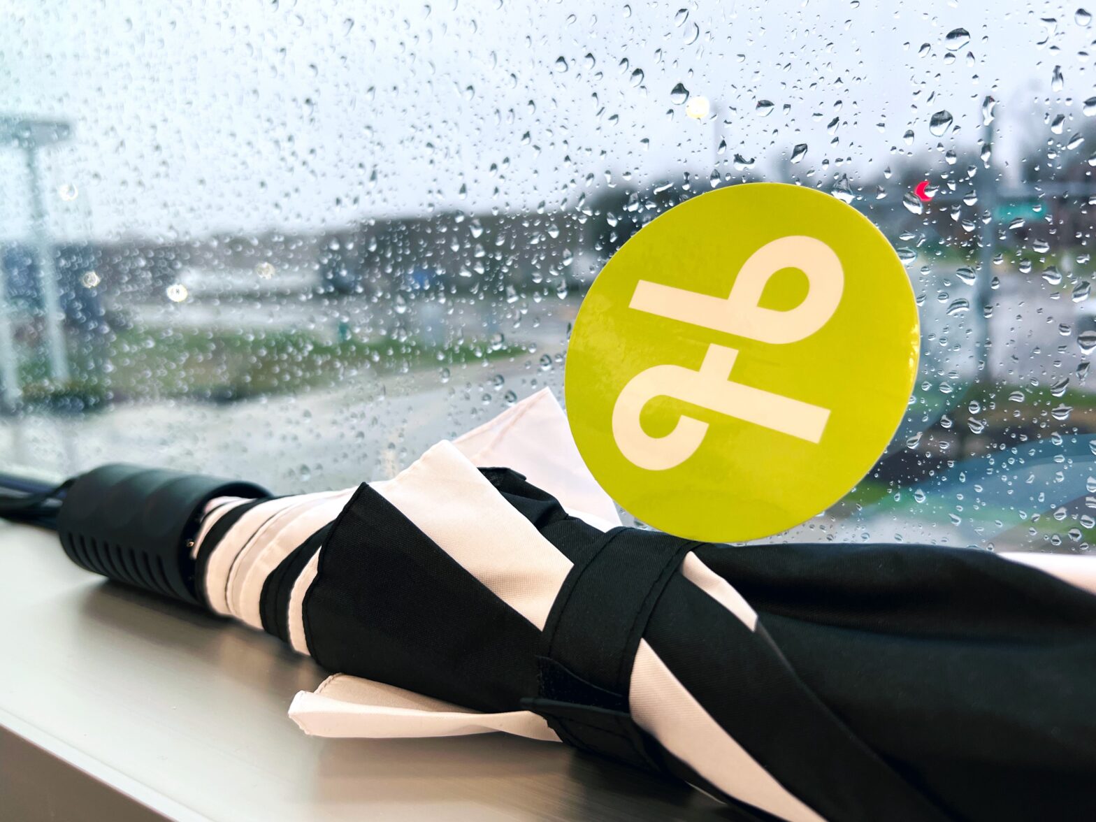 umbrella in rainy widow with Lextran logo